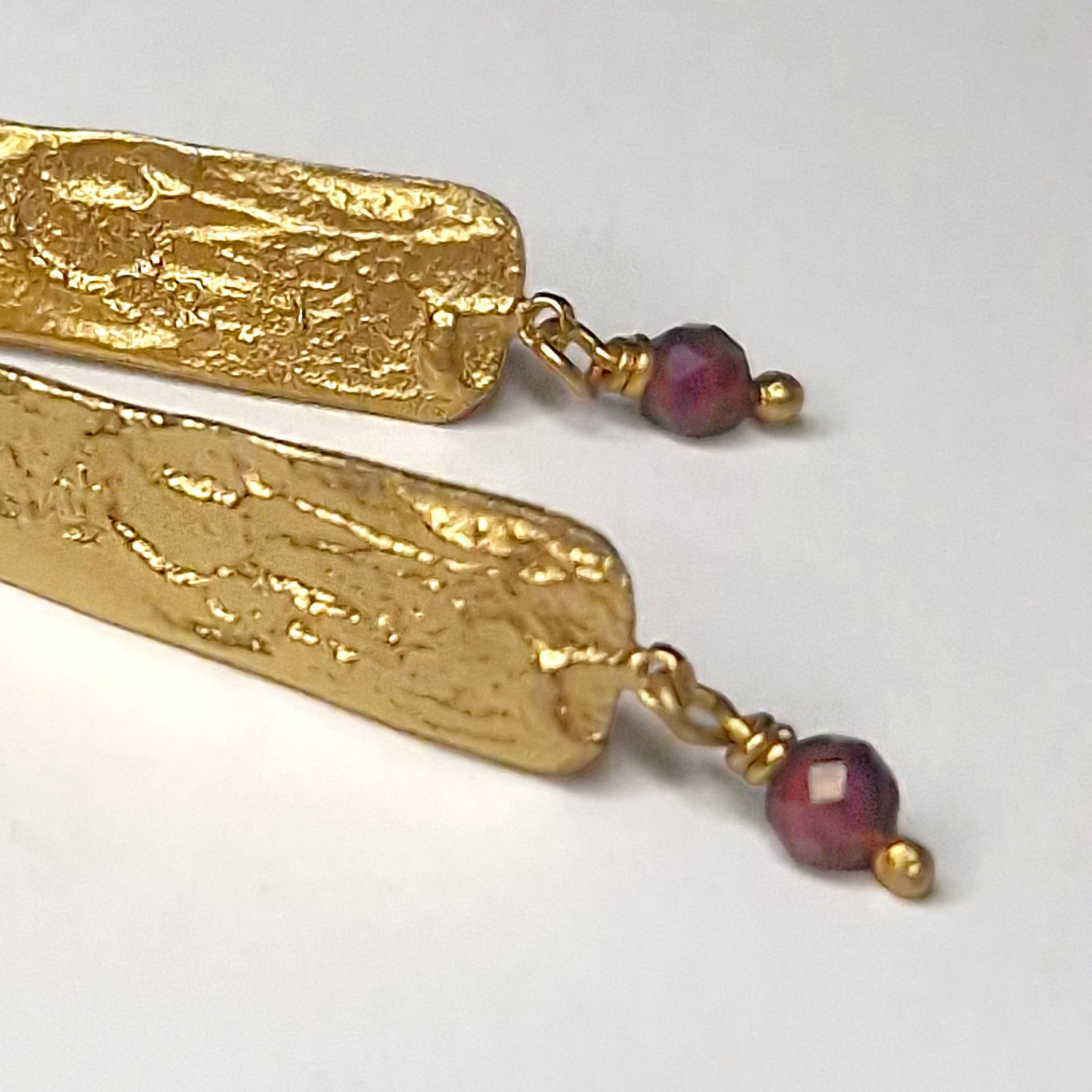 Gold plated sterling silver long stud earrings with Garnet