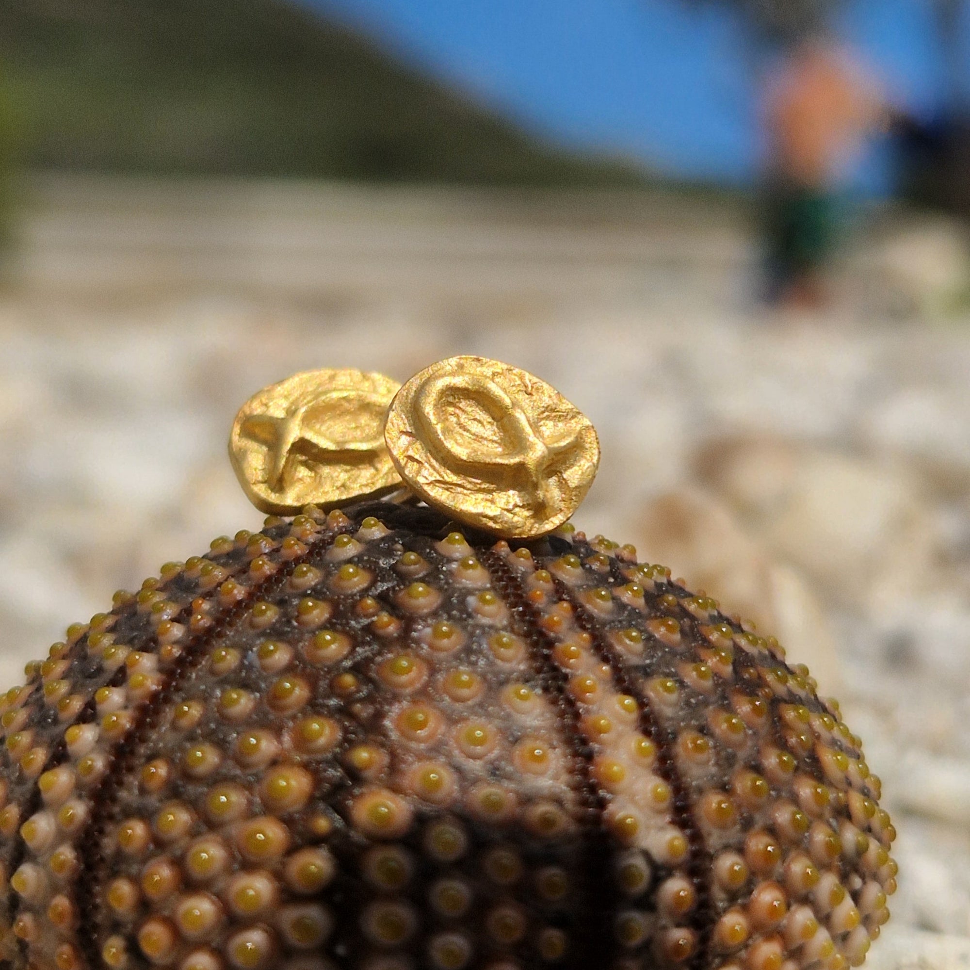 Small gold-plated sterling silver fish earrings, hand carved design.