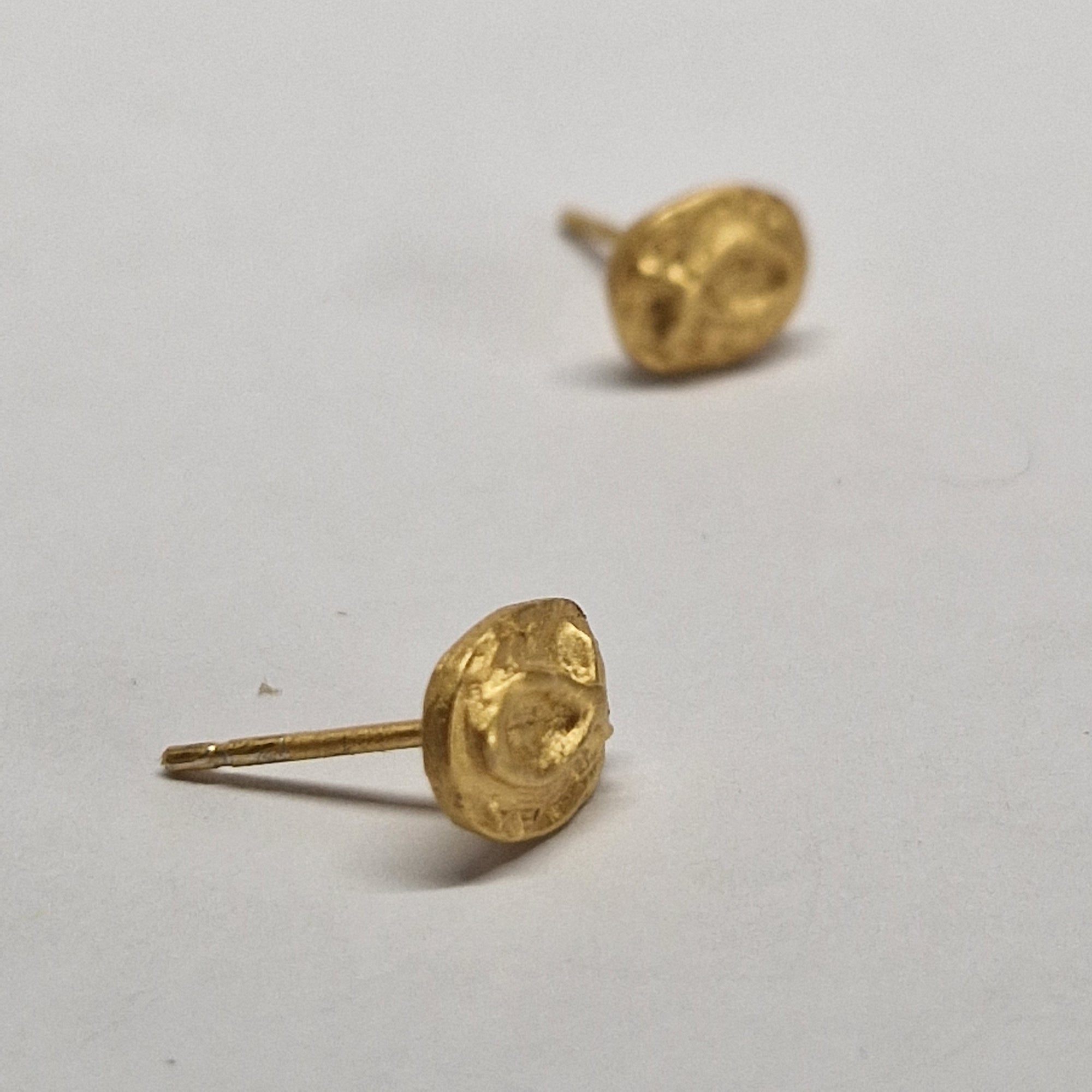 Small gold-plated sterling silver fish earrings, hand carved design.
