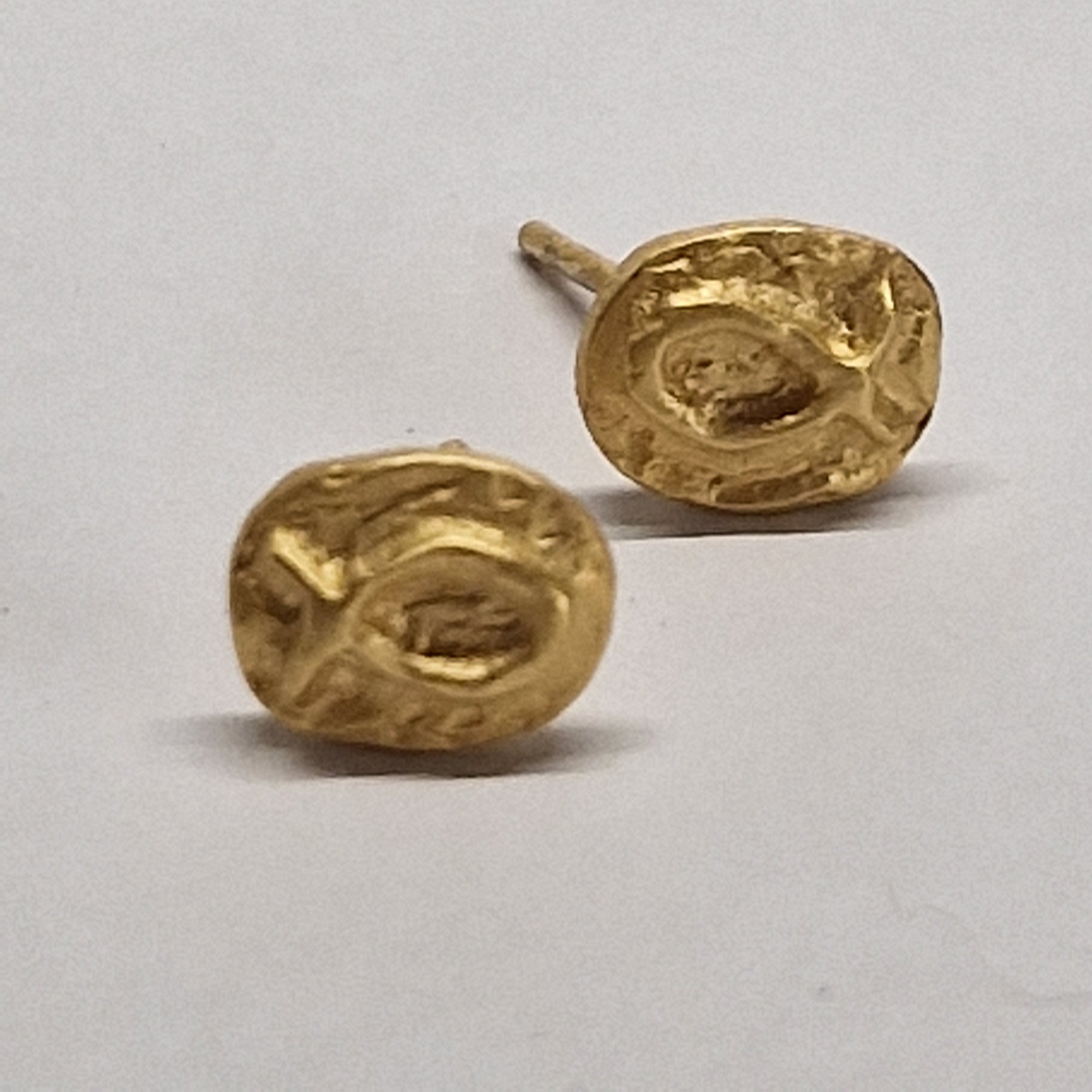 Small gold-plated sterling silver fish earrings, hand carved design.