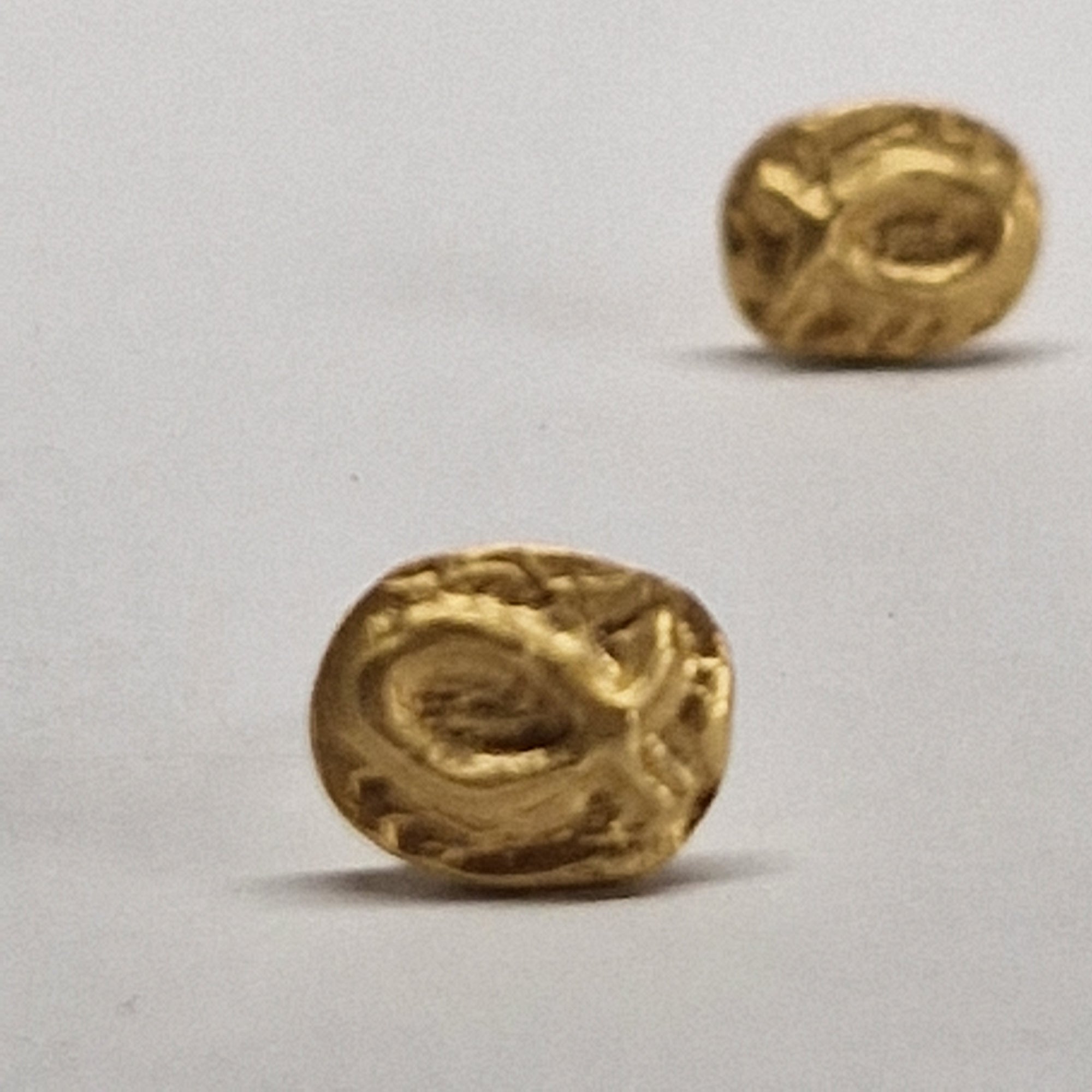Small gold-plated sterling silver fish earrings, hand carved design.