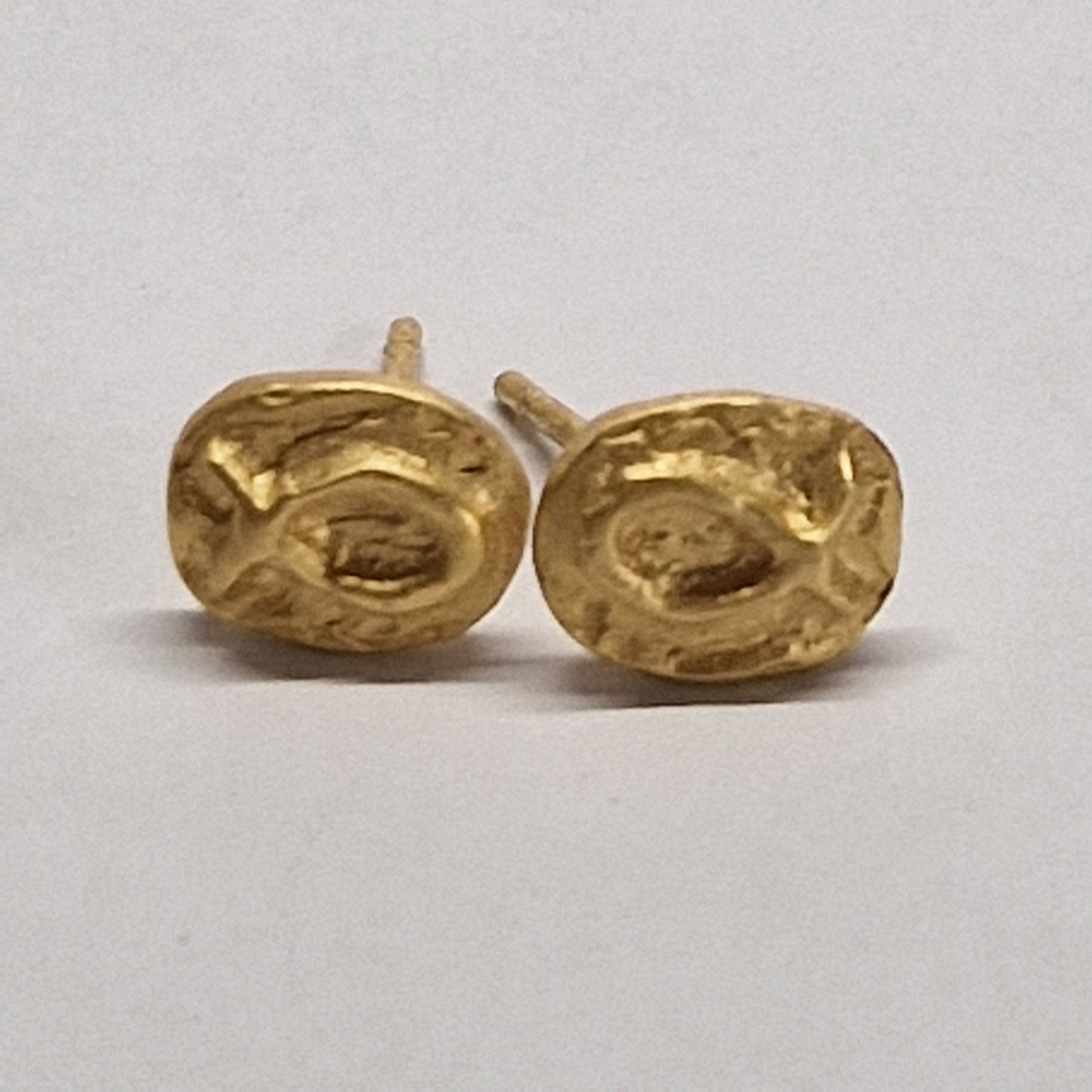 Small gold-plated sterling silver fish earrings, hand carved design.
