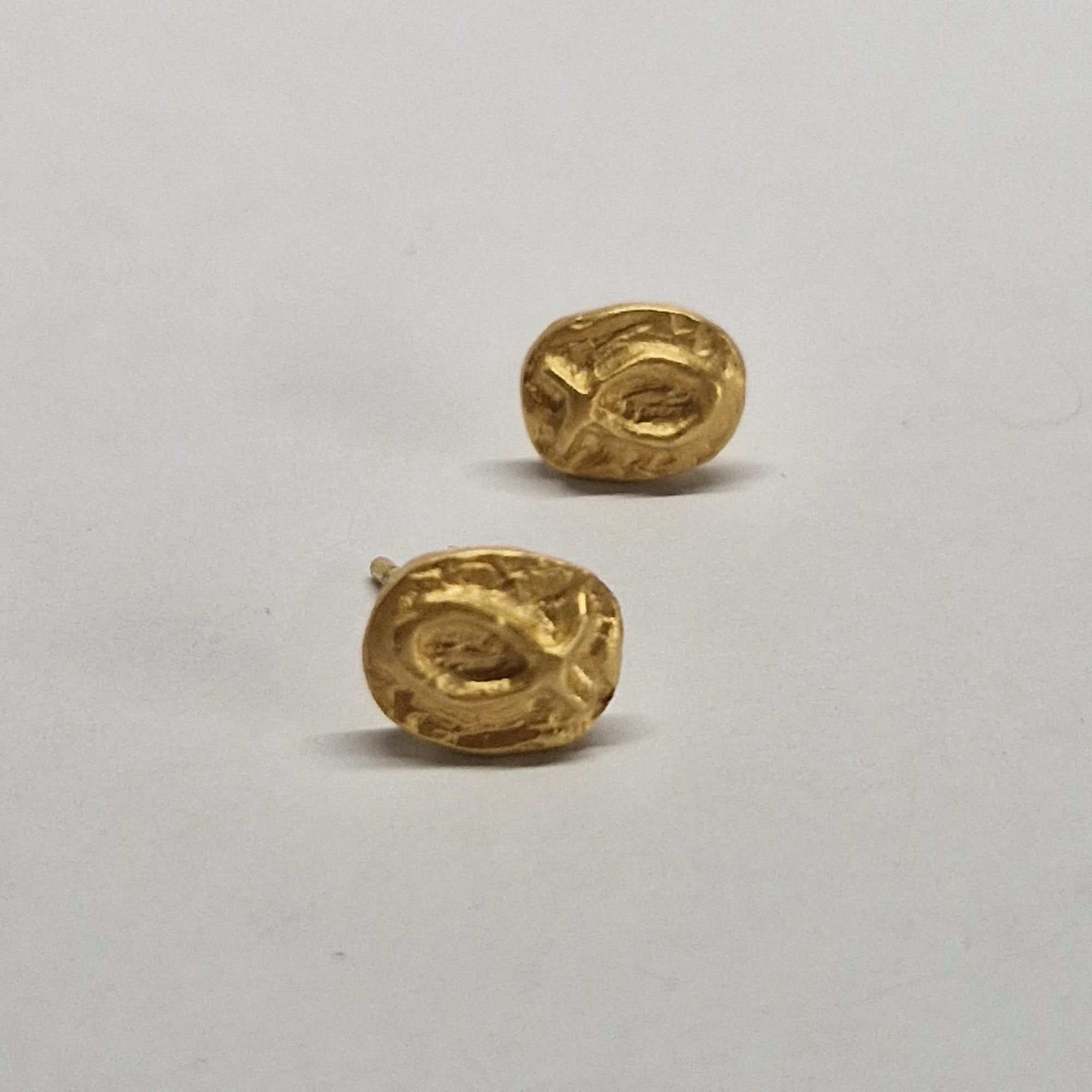 Small gold-plated sterling silver fish earrings, hand carved design.