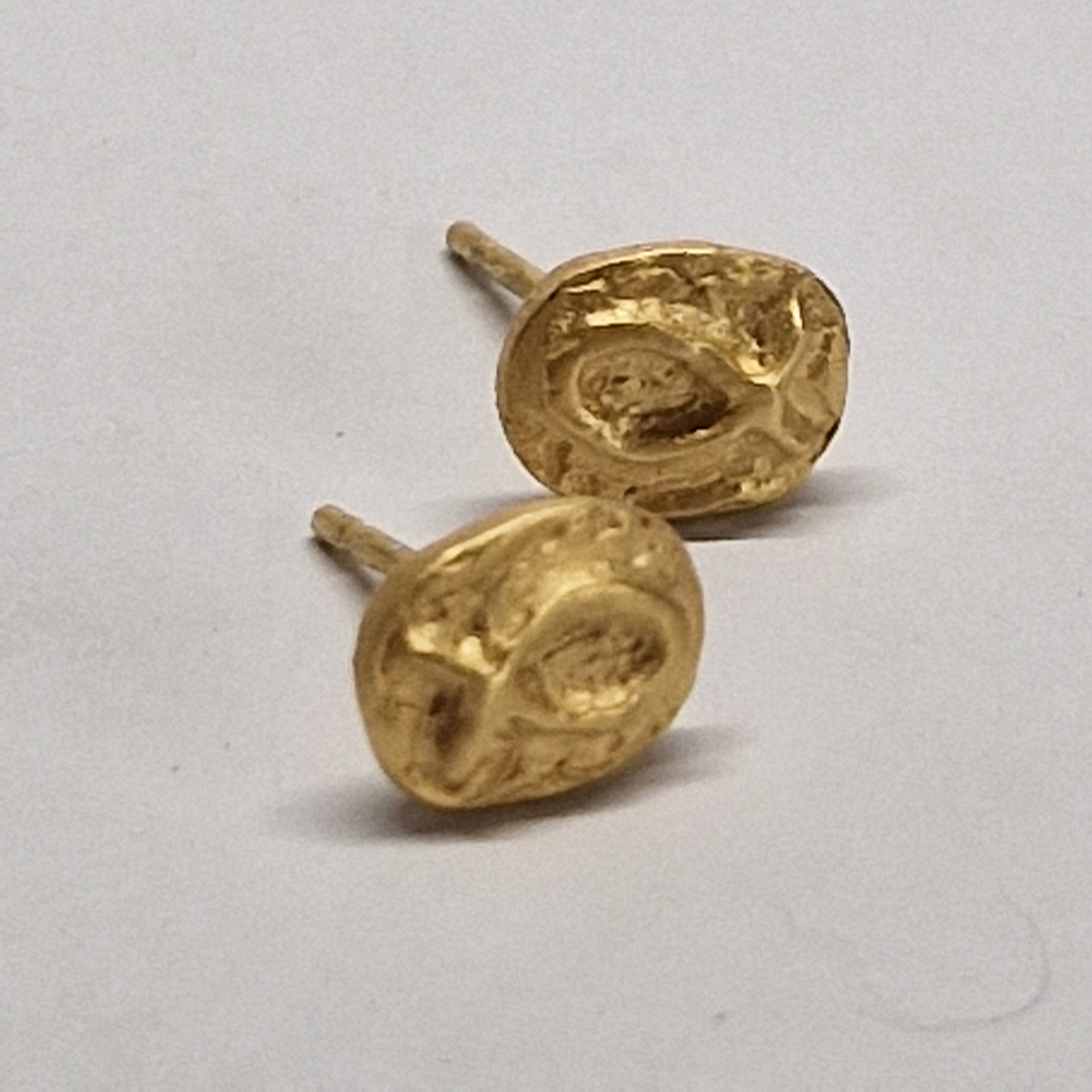 Small gold-plated sterling silver fish earrings, hand carved design.