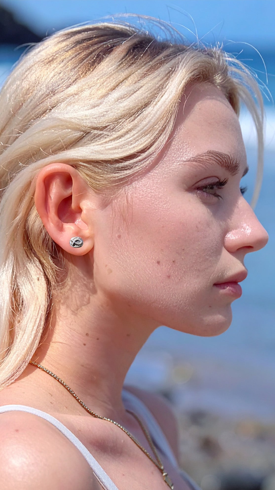 Small sterling silver fish earrings, hand carved design.