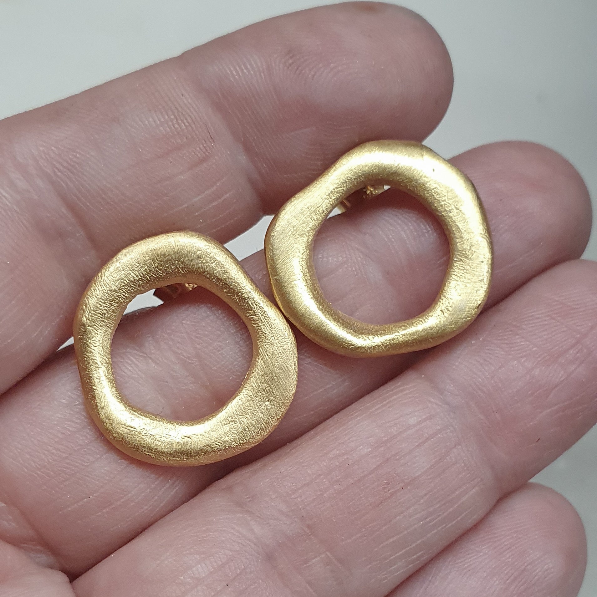 Medium - sized Gold plated front facing hoops.