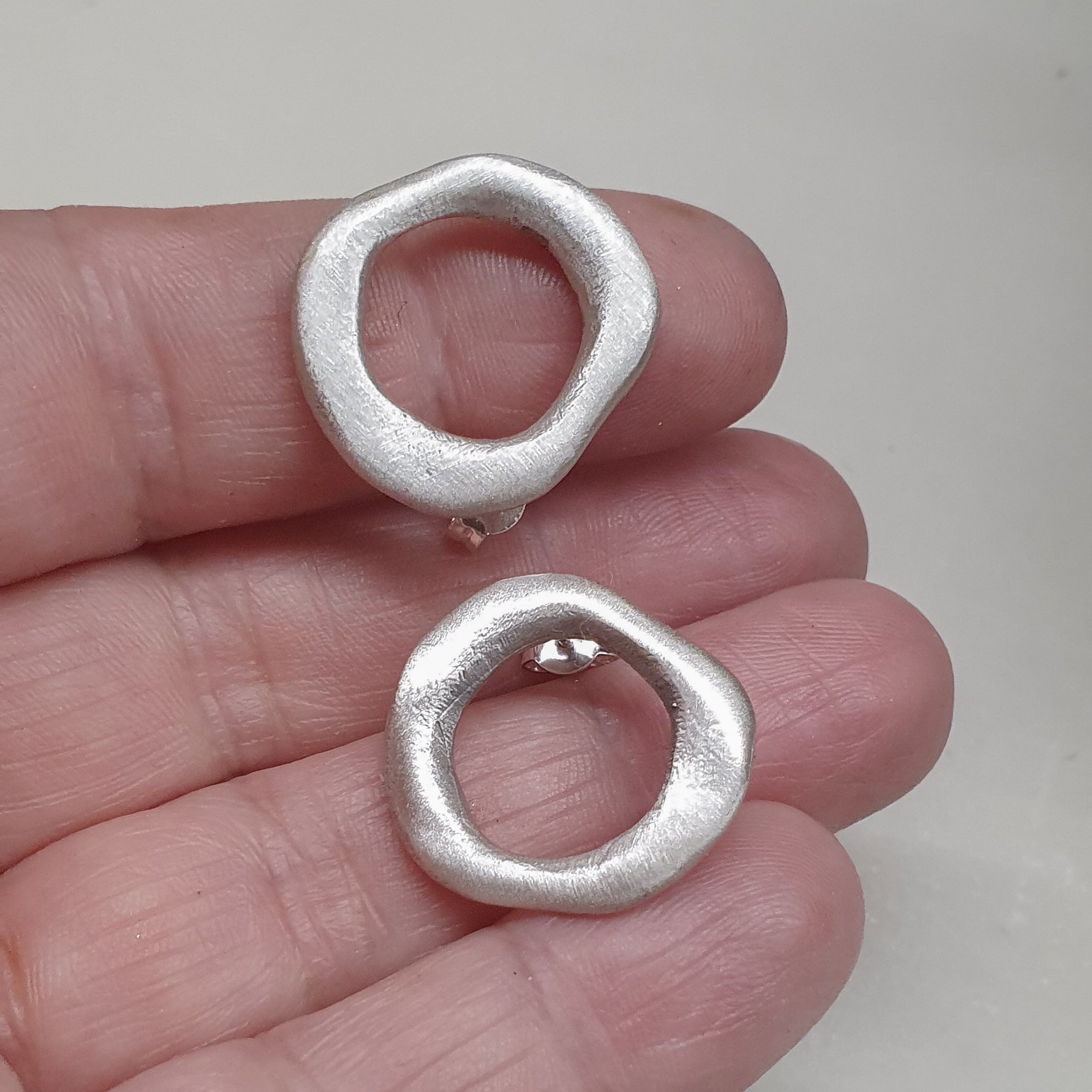 Medium - sized silver front facing hoops