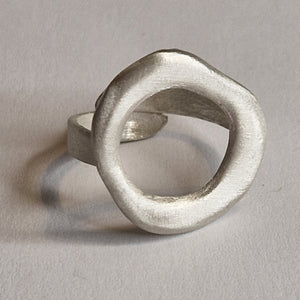 Silver ring with a unique design on a gray background