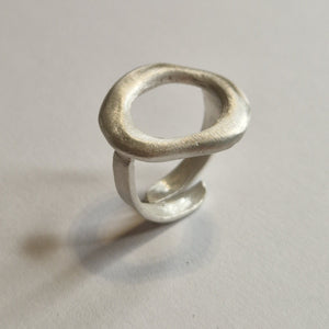 Silver ring on a light gray background