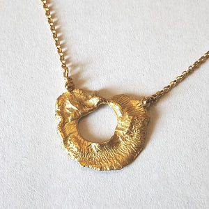 Close-up of VOLCANO textured matte gold plated sterling silver pendant